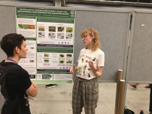 Savanna presents her poster on treehopper helmet evo-devo at the Evolution conference