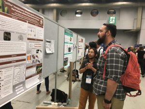 Asher Coello presents his poster on new genes in hemipterans at the Evolution Conference in 2024